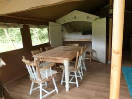 A dining area with a table and chairs at Teifi Newcastle Emlyn