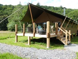 A tent with a deck area and furniture at Teifi in Newcastle Emlyn