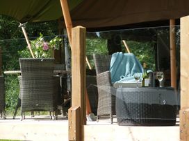 An outdoor seating area with chairs and a table at Teifi in Newcastle Emlyn