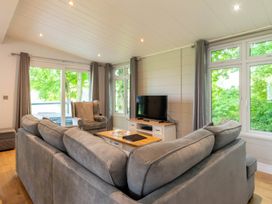 A living room with a sofa and a television at Bainbridge (Pet) Leyburn