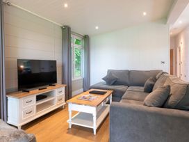 A living room with a television and a sofa at Bainbridge (Pet) Leyburn