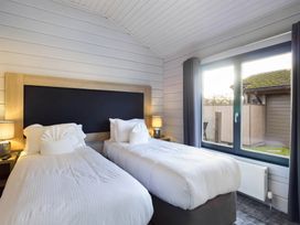 A bedroom with two beds and a window at Leyburn Leyburn