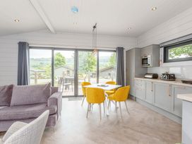 A living room with a dining area and kitchen appliances at Leyburn (Pet) Leyburn
