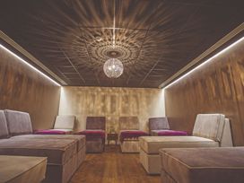 A relaxation room with couches and a chandelier at Tennyson Spa in Louth