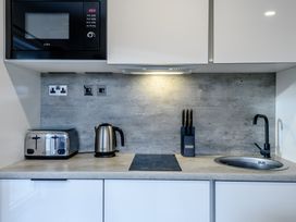 A kitchen countertop with appliances and a sink at Somersby Spa (Pet) in Louth