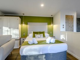 A bedroom with a bed and sofa at Somersby Spa (Pet) Louth