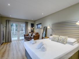 A bedroom with a bed and a sofa at Tennyson Spa (Pet) Louth