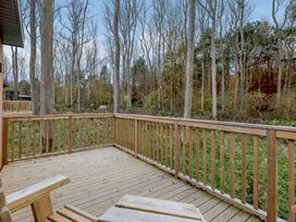 A deck overlooking trees and grass at Tennyson Spa (Pet) in Louth