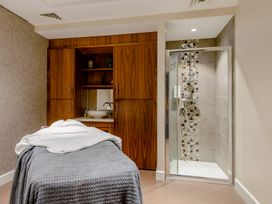 A spa room with a massage table and shower at Tennyson Spa (Pet) in Louth