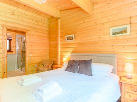 A bedroom with a bed and a shower at Maple Lodge Louth