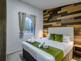 A bedroom with a bed and window at Anderby Spa (Pet) Louth