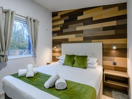 A bedroom with a bed and window at Anderby Spa (Pet) Louth