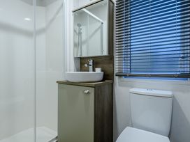 A bathroom with a shower, sink, and toilet at Anderby Spa (Pet) Louth