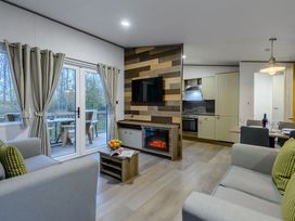 A living room with a television and dining area at Anderby Spa (Pet) Louth