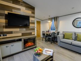 A living room with a TV and sofa at Anderby Spa (Pet) Louth