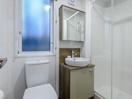 A bathroom with a sink toilet and shower at Anderby Spa (Pet) Louth