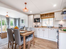 A kitchen with table and chairs at Caistor Spa in Louth