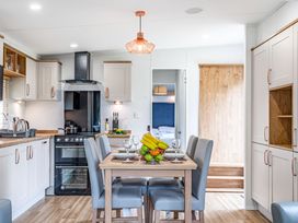 A kitchen with a dining table and chairs at Caistor Spa in Louth