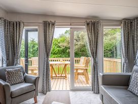 A living room with sliding doors leading to a deck at Caistor Spa in Louth