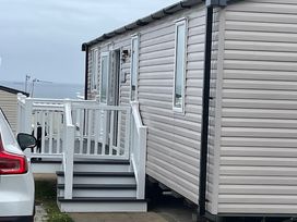 A static caravan with steps and a car parked at No 19 Cliff top park in Hartlepool