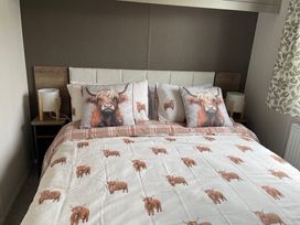 A bedroom with bed and decorative pillows at No 19 Cliff top park in Hartlepool