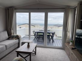 A living room with a sofa and coffee table at No 19 Cliff top park Hartlepool