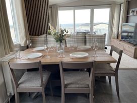 A dining room with a table set for dinner at No 19 Cliff top park, Hartlepool