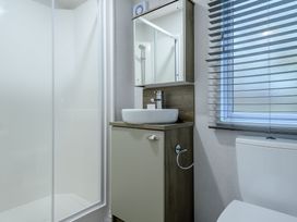A bathroom with a shower, sink and toilet at Alford Spa in Louth