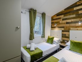 A bedroom with two beds and a window at Alford Spa in Louth