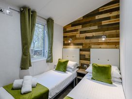 A bedroom with two beds and a window at Alford Spa in Louth