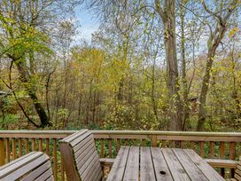 A deck area with a table and benches overlooking trees at Alford Spa, Louth