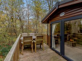 An outdoor deck with chairs and a table at Alford Spa in Louth