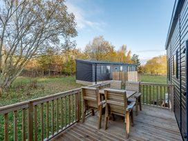 An outdoor area with a deck and seating at Horncastle Spa Louth