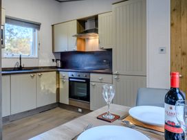 A kitchen with cabinets and a dining setup at Horncastle Spa Plus in Louth