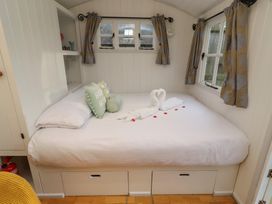 A bedroom with a bed and decorative pillows at Meadows in Hexham