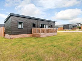 A lodge with decking and grass area at The Kinder Spa (Pet) Louth
