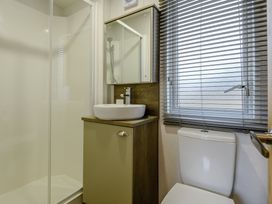 A bathroom with a shower, sink, and toilet at The Kinder Spa (Pet) Louth