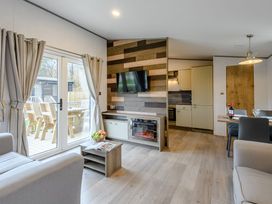 A living room with a television and dining table at The Kinder Spa (Pet) Louth
