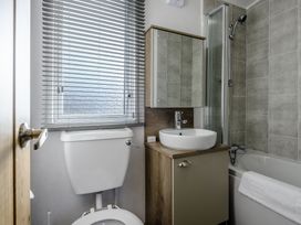 A bathroom with a toilet, sink, shower and bathtub at The Kinder Spa (Pet) Louth