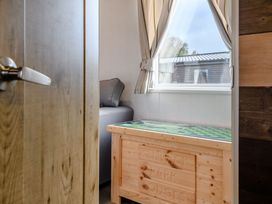 A living room with a window and a chest at The Kinder Spa (Pet) Louth