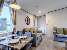 A living room with a dining table and seating area at The Kinder Spa (Pet) Louth