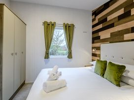 A bedroom with a bed and wardrobe at The Kinder Spa (Pet) Louth