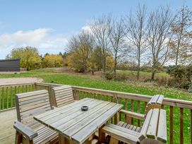 An outdoor seating area with a table and chairs at The Kinder Spa (Pet) Louth