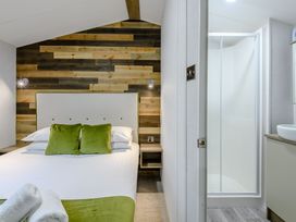 A bedroom with a bed and attached bathroom at Alford Spa (Pet) Louth