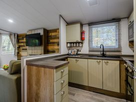 A kitchen with cabinets and sink at Alford Spa (Pet) in Louth
