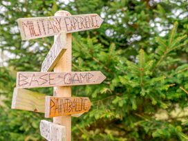 A signpost with directional arrows labeled military experience, base camp, and paintballing at Alford Spa (Pet) Louth