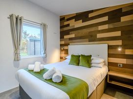 A bedroom with a bed and window at Horncastle Spa (Pet) Louth