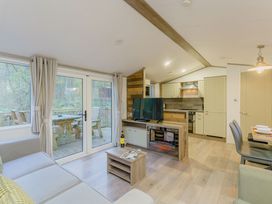 A living room with a television and sofa at Horncastle Spa Plus (Pet) in Louth