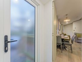 A dining room with a table and chairs visible through a door at Horncastle Spa Plus (Pet) in Louth