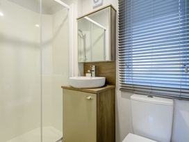 A bathroom with a shower, sink, and toilet at Horncastle Plus (Pet) in Louth
